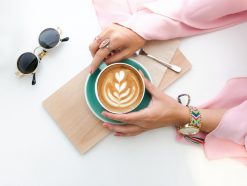 woman holding cup of latte 1260591